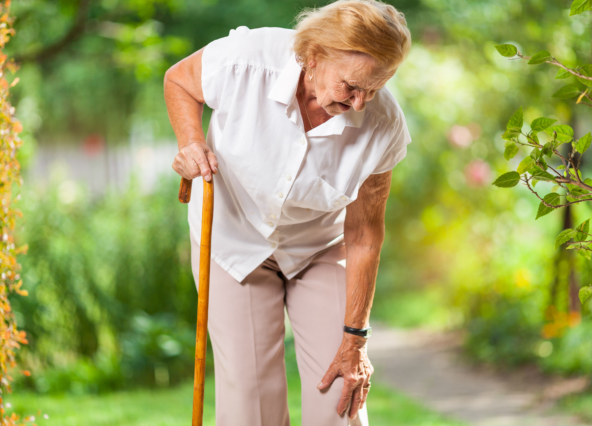 Aging woman with a cane.