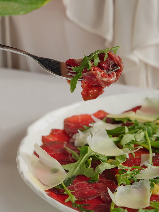 A raw meat carpaccio meal.
