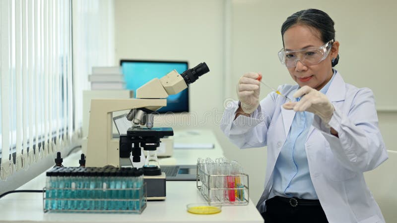 Woman in lab doing an experiment.