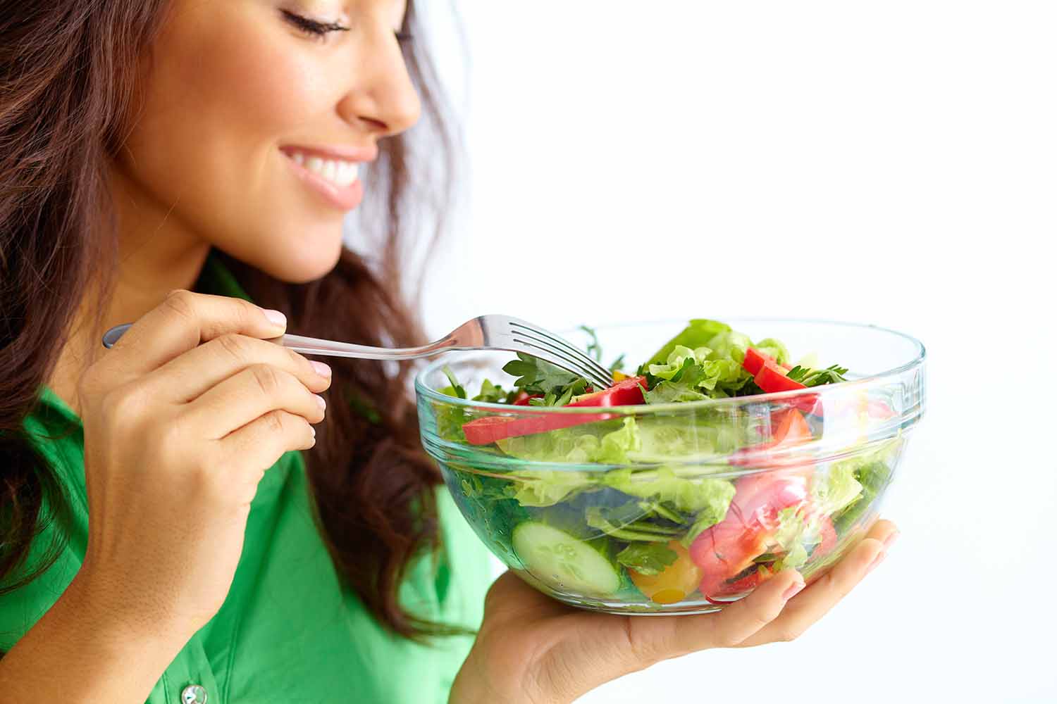 Woman eating a fresh salad.