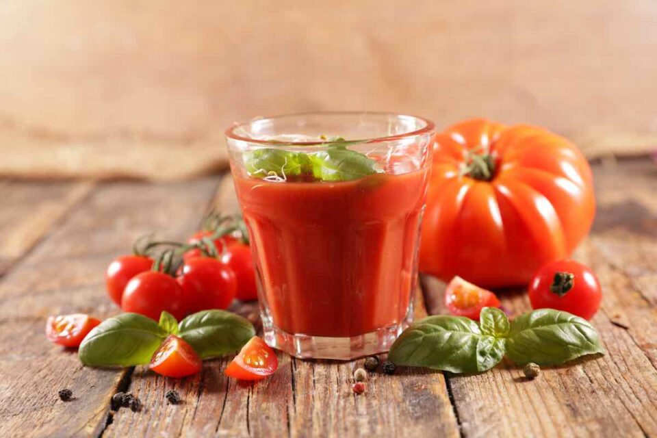 Make a simple tomato juice with basil leaves and tomatoes.