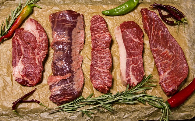 Different cuts of aged raw meats.