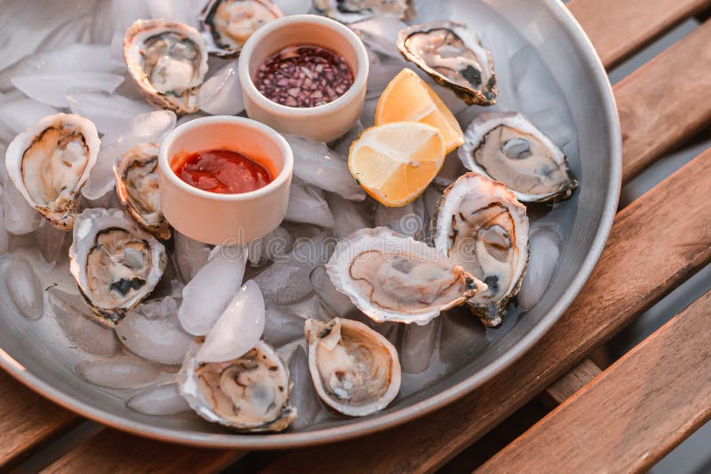 Raw oyster platter with condiments. Raw oyster platter with condiments.