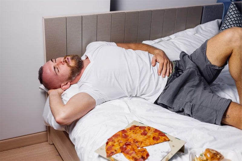 Man falling asleep after eating a cooked meal.