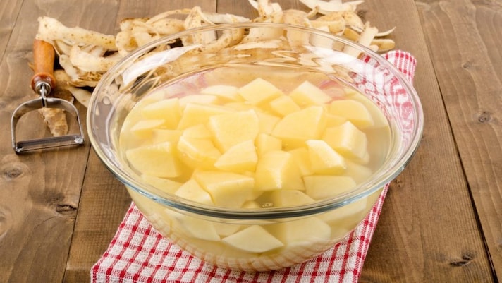 Cut potatoes soaking in water to help reduce acrylamide formation.