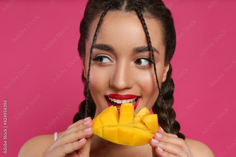 Woman eating fresh mango.